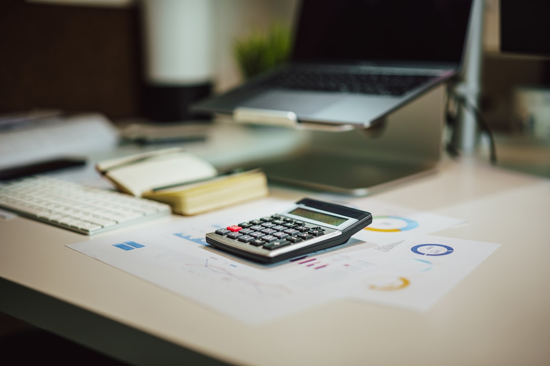 Home office desk with calculator and tax forms, freelancer tax deduction concept