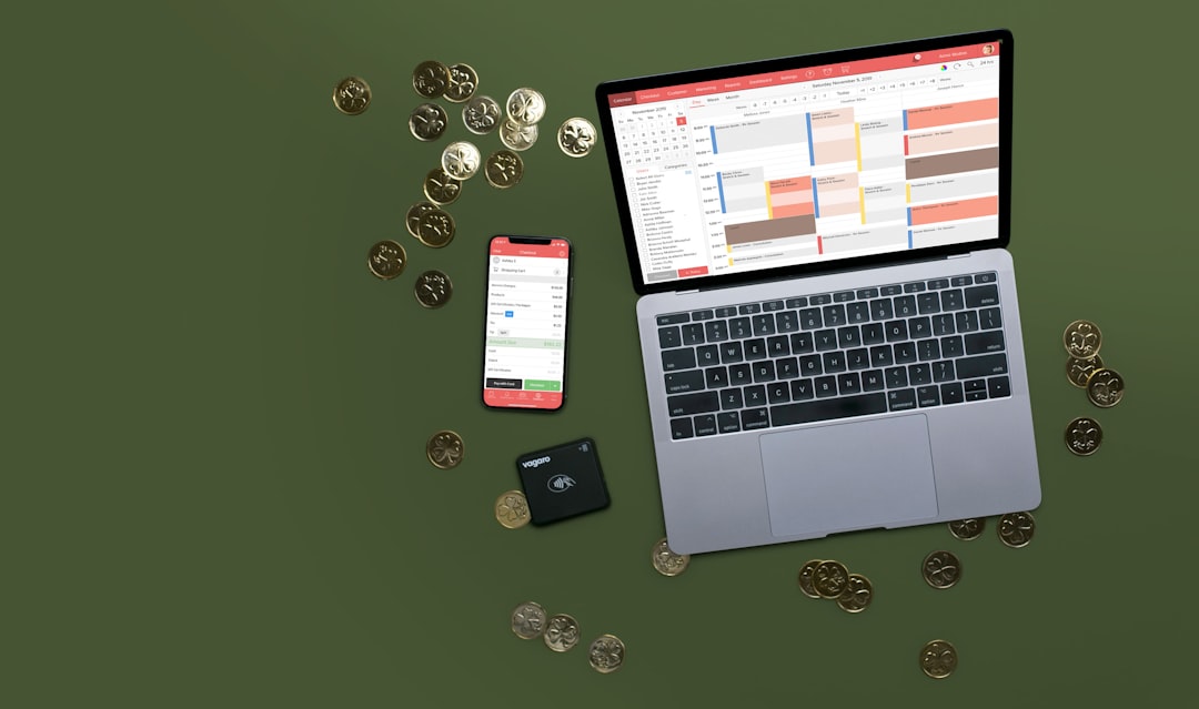Freelancer calculating sales tax on laptop with receipts nearby