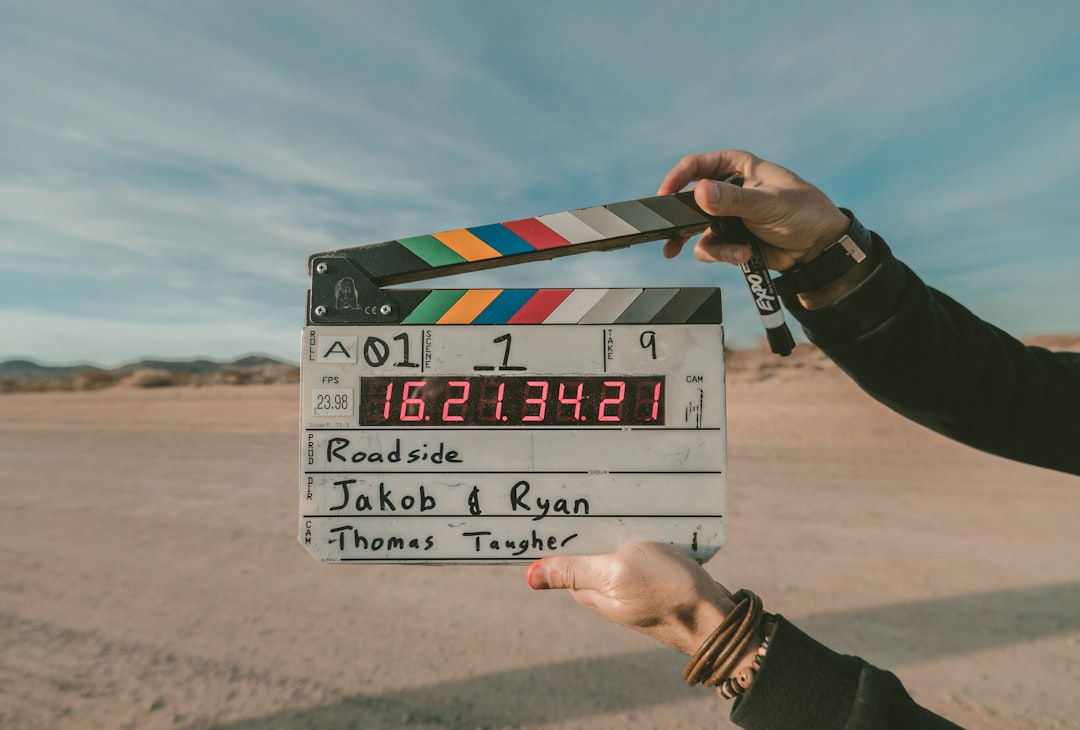 Freelancer reviewing a video production contract with camera equipment nearby